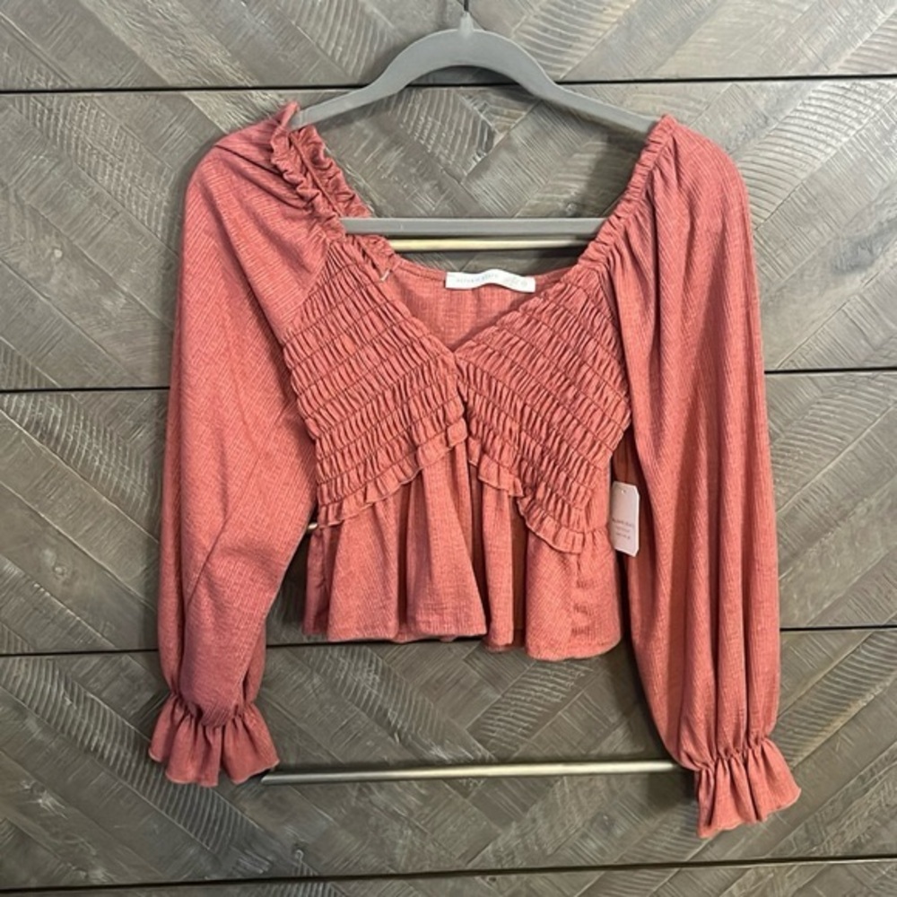 Altar'd State Smocked Ruffle Blouse in Coral Pink